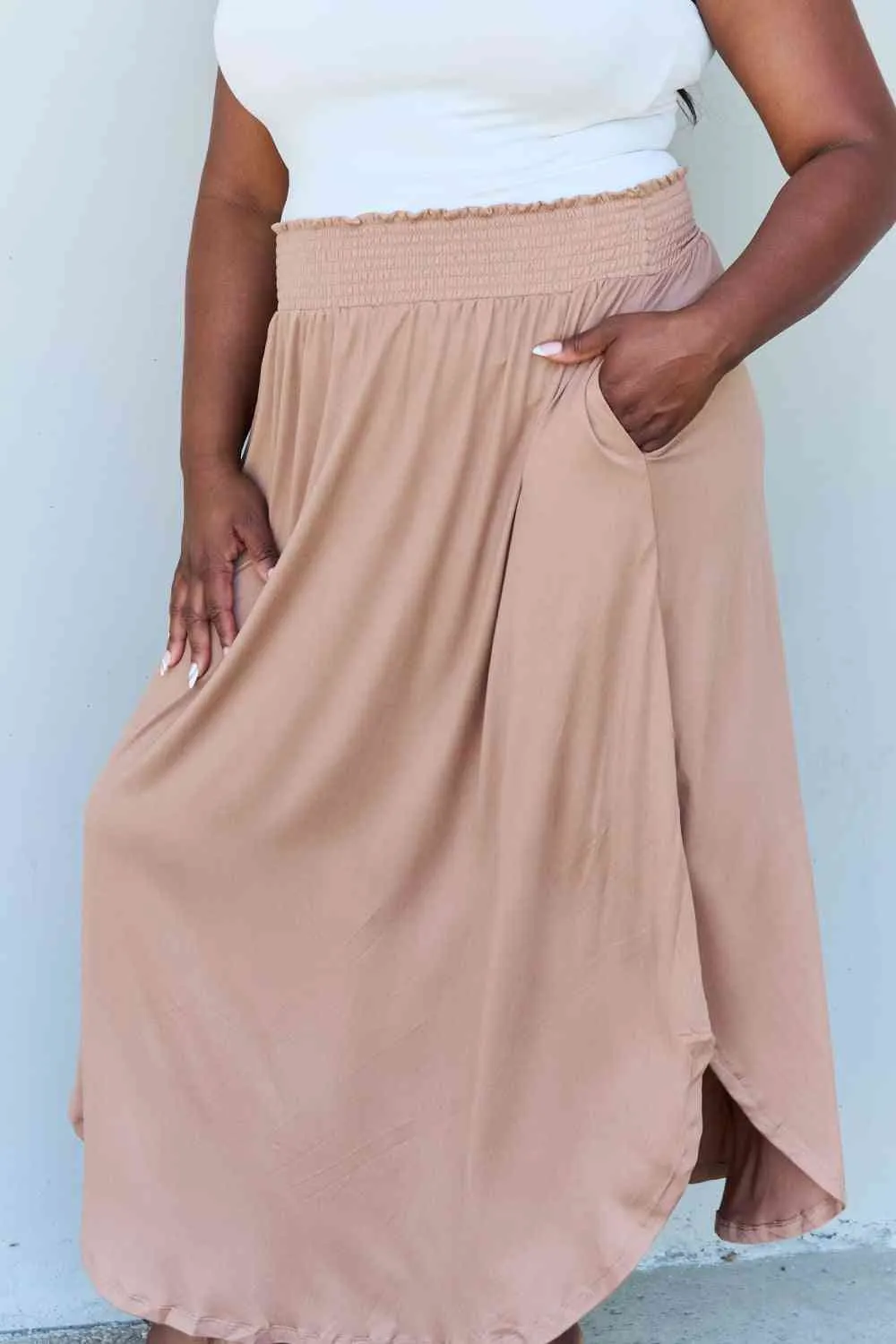 The Nina High Waist Scoop Hem Maxi Skirt in Tan