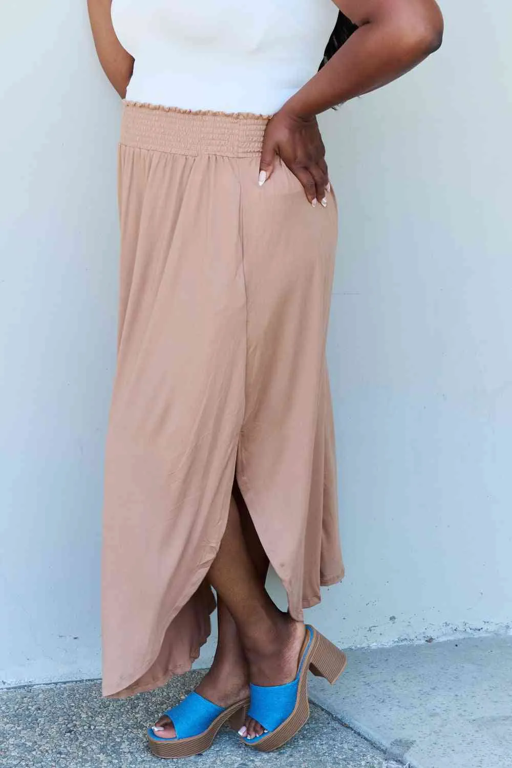 The Nina High Waist Scoop Hem Maxi Skirt in Tan